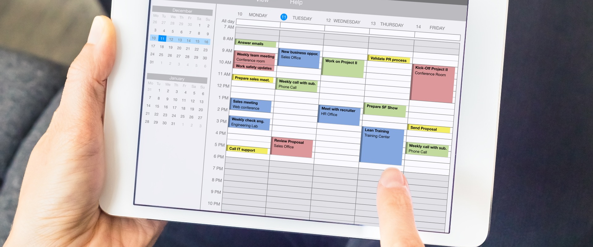 Calendar app on tablet computer with planning of the week with appointments, events, tasks, and meeting. Hands holding device, time management concept, organization of working hours planner, schedule