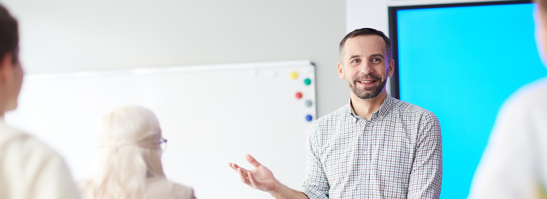Happy confident teacher explaining his students what he thinks about new subject