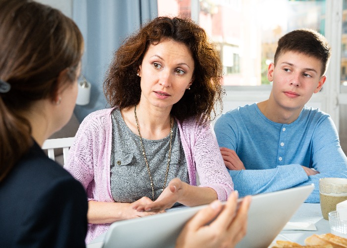 Woman with son meeting with tutor