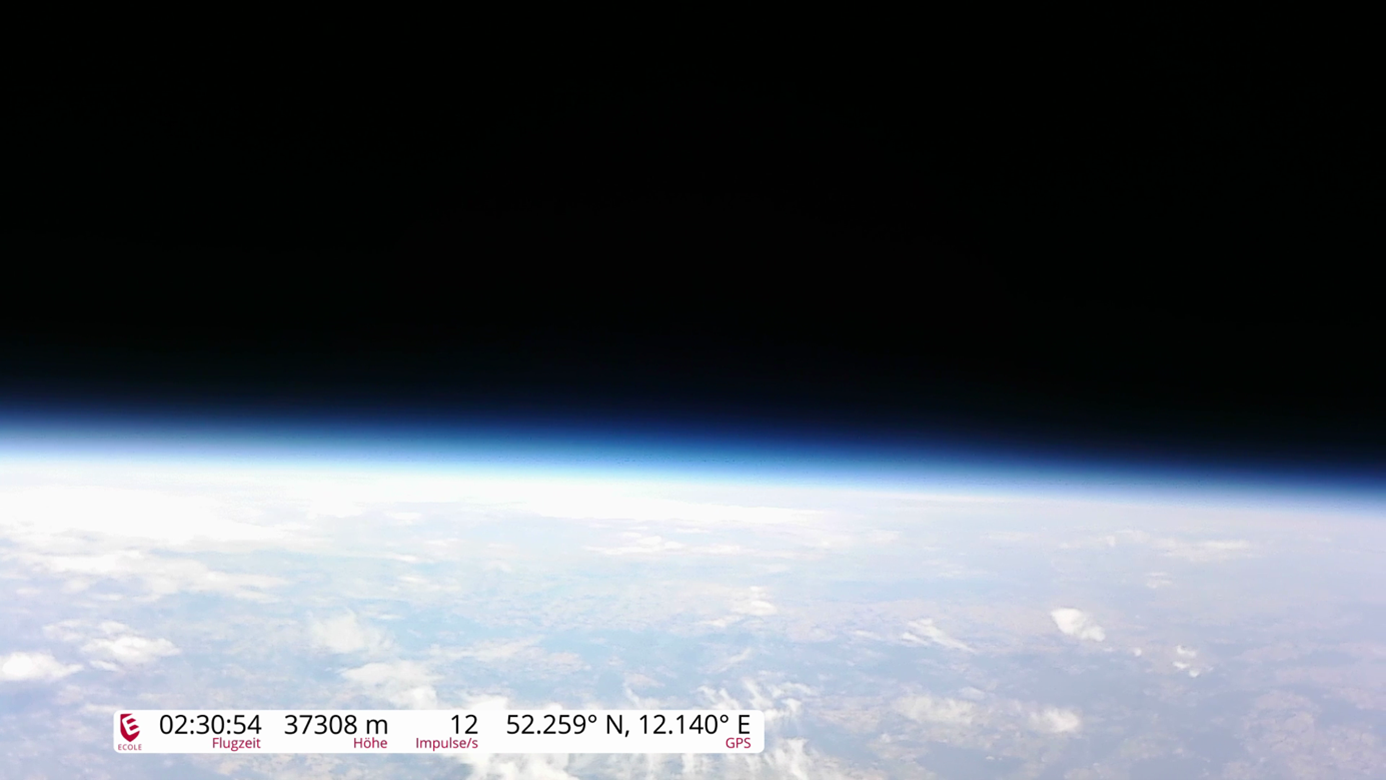 Blick aus großer Höhe auf die Erde mit sichtbarer Erdkrümmung und dunklem Himmel